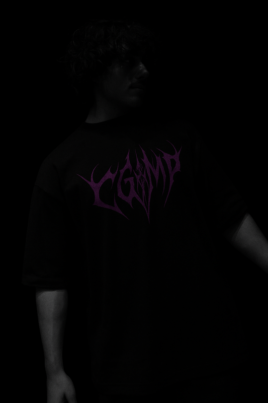 Person wearing a black t-shirt with purple text on a dark background