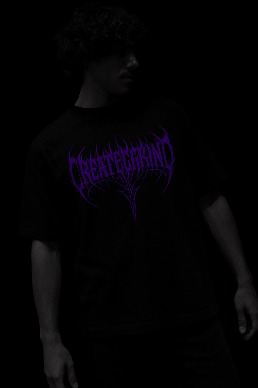Person wearing a black t-shirt with purple text on a dark background