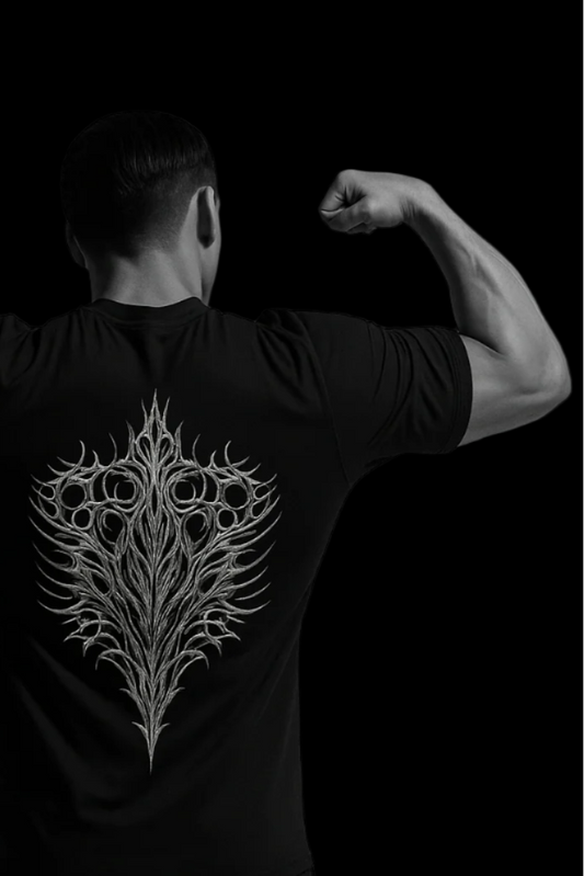 Person wearing a black t-shirt with a white intricate design on the back, against a black background